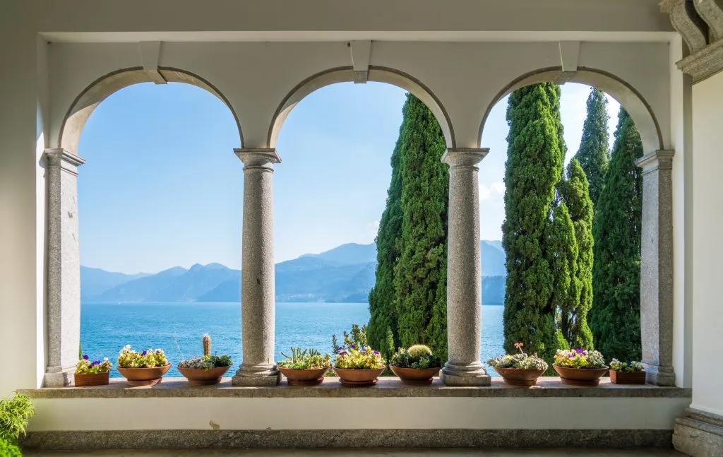 view through the arches at villa monastero, a fun destination on a day trip lake como italy
