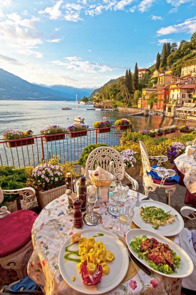 plates of pasta on a picturesque restaurant terrace in lake como day trip from milan