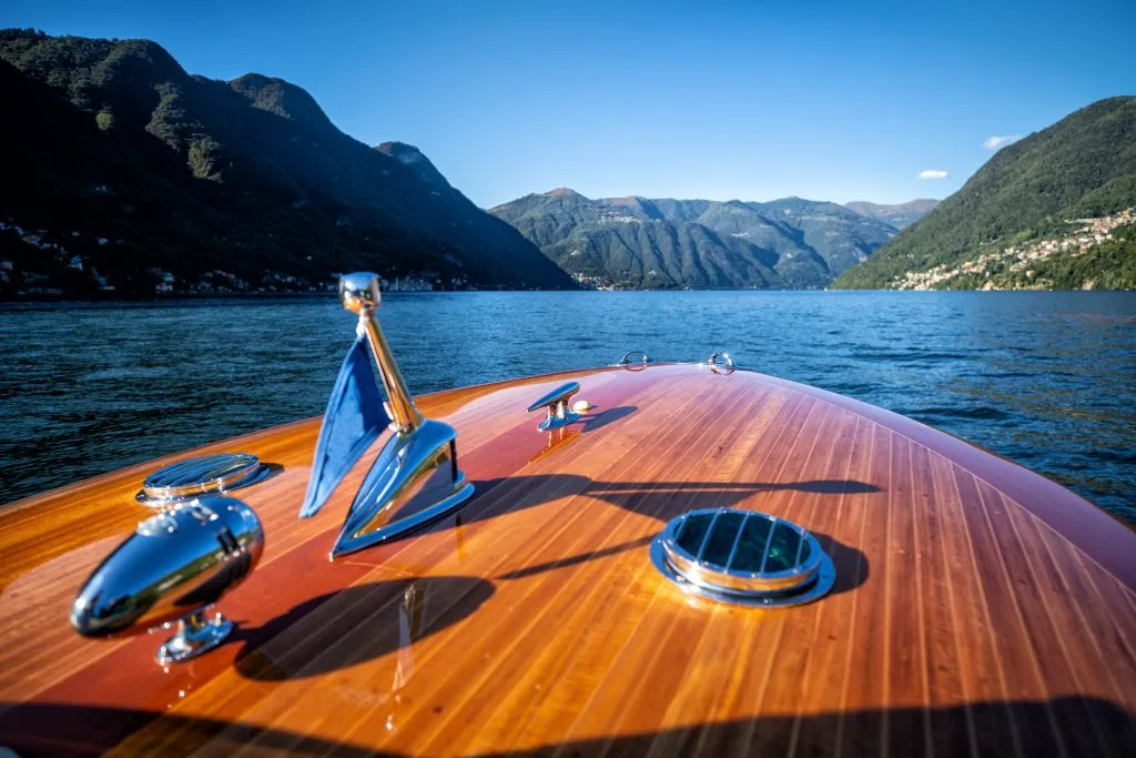 front bow of a wooden sightseeing boat on lake como, one of the best things to do in lake como in a day