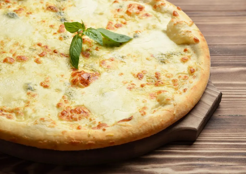 pizza quattro formaggi as seen from the side, one of the traditional pizzas to eat in italy