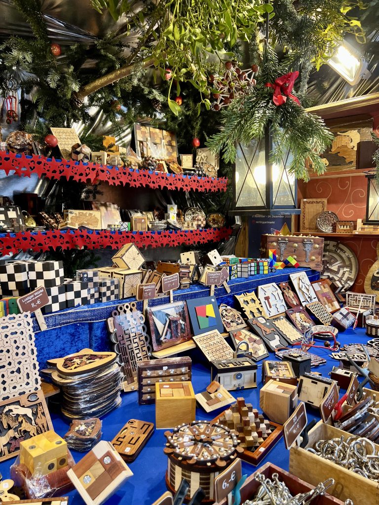 stall of wooden carvings and toys for sale at a bavaria christmas market