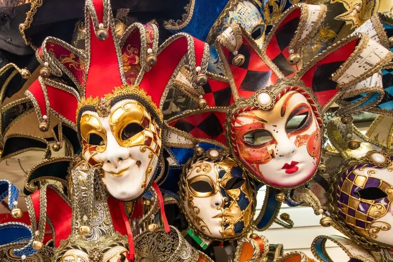collection of venetian masks for sale as venice souvenirs, one of the best things to buy in venice italy