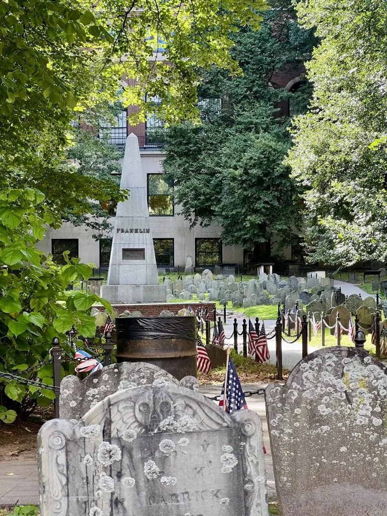 granary burying ground along boston freedom trail with franklin monument prominent in the photo, part of a one day in boston itinerary