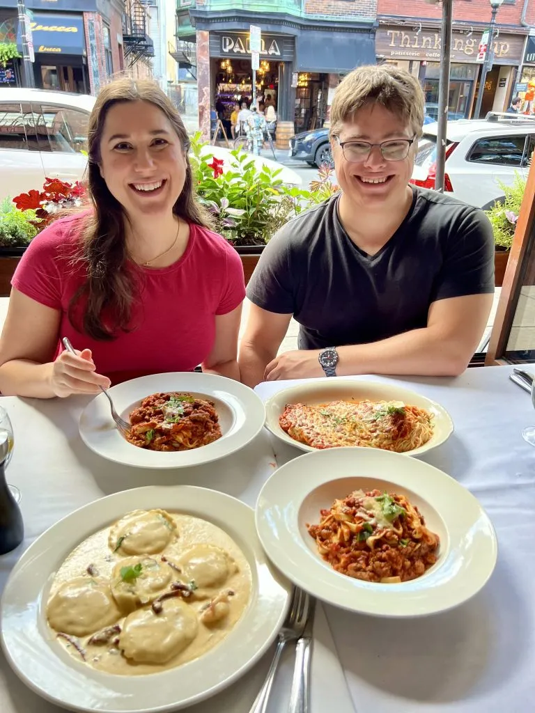 kate storm and jeremy storm dining at tresca in the north end boston with several pastas in front of them