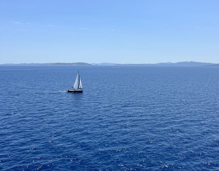 view of a sailboat from the deck of grimaldi lines ferry from barcelona to rome