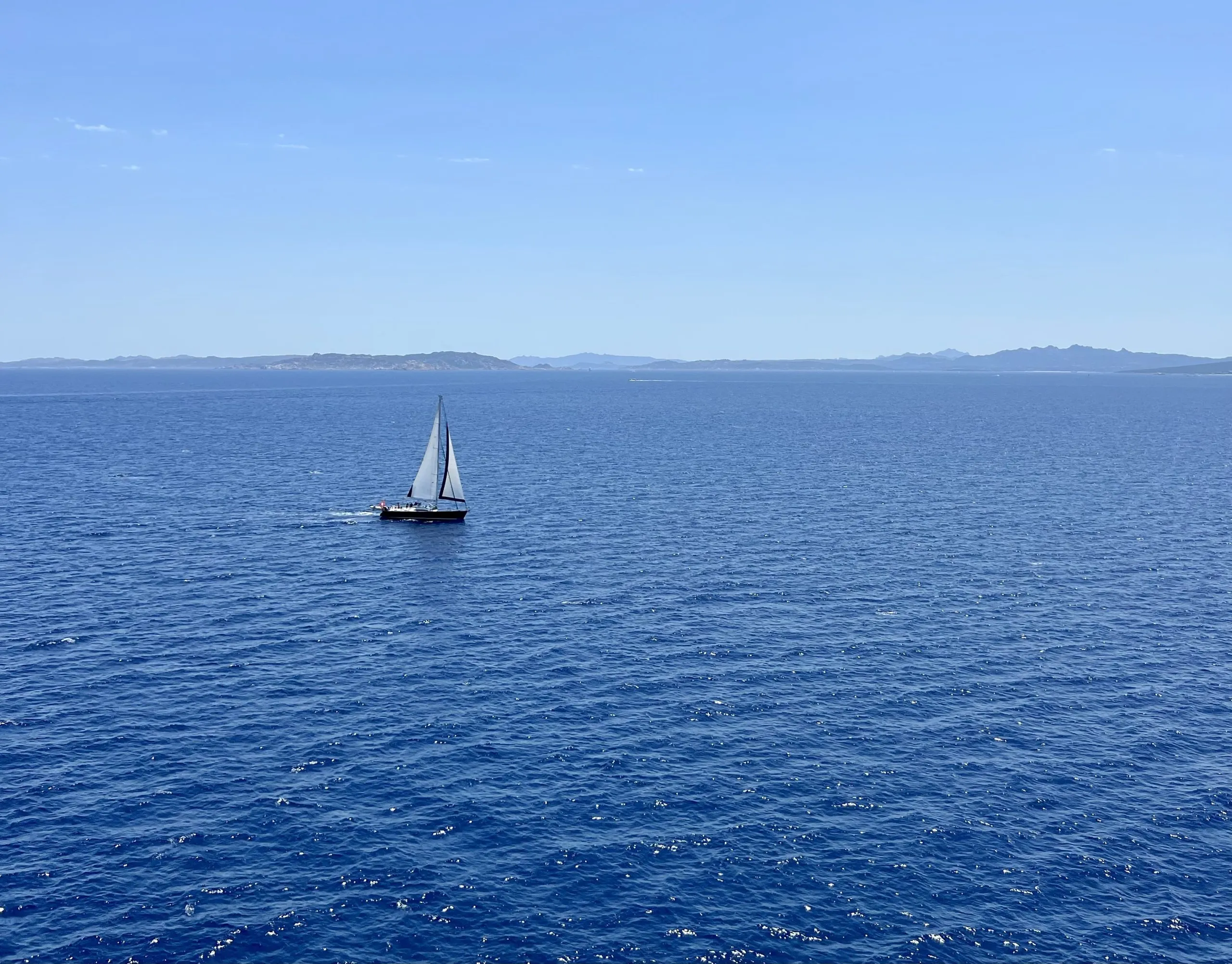 view of a sailboat from the deck of grimaldi lines ferry from barcelona to rome