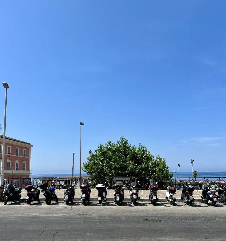 motorcycles parked in civitavecchia italy with sea in the background