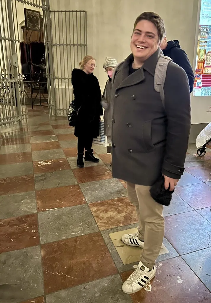 jeremy storm with his foot in the devils footprint in frauenkirche, a fun stop during a 1 day munich itinerary
