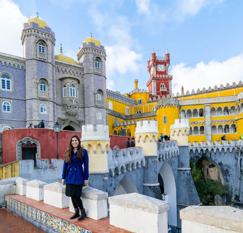 kate storm in front of pena palace on a day trip to sintra from lisbon