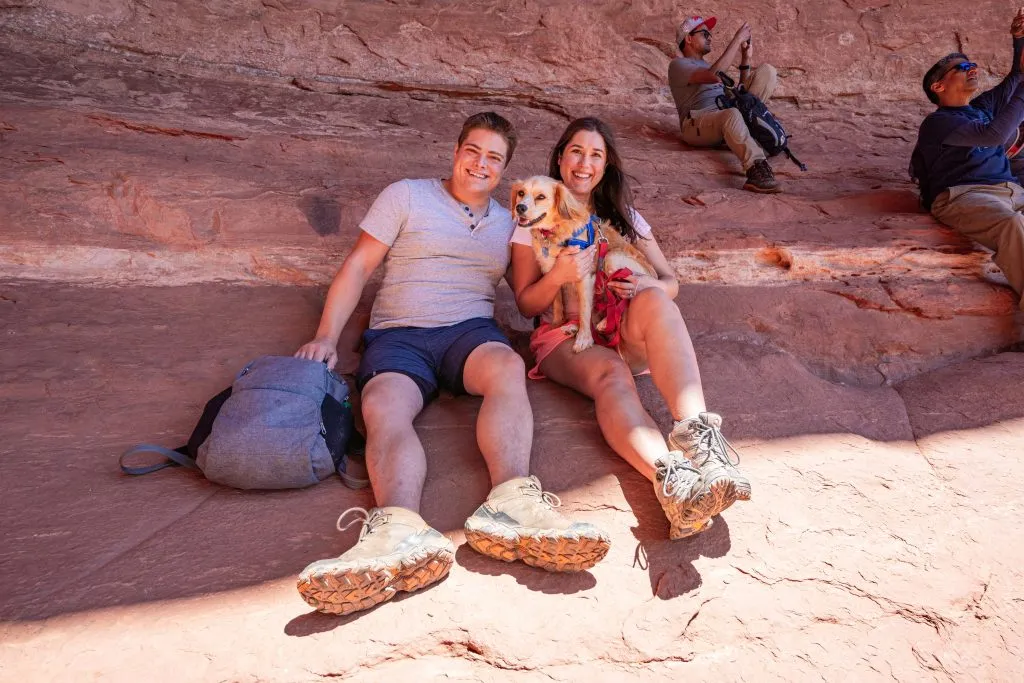 kate storm jeremy storm and ranger storm resting in a cave while hiking in sedona as part of a road trip itinerary southwest usa