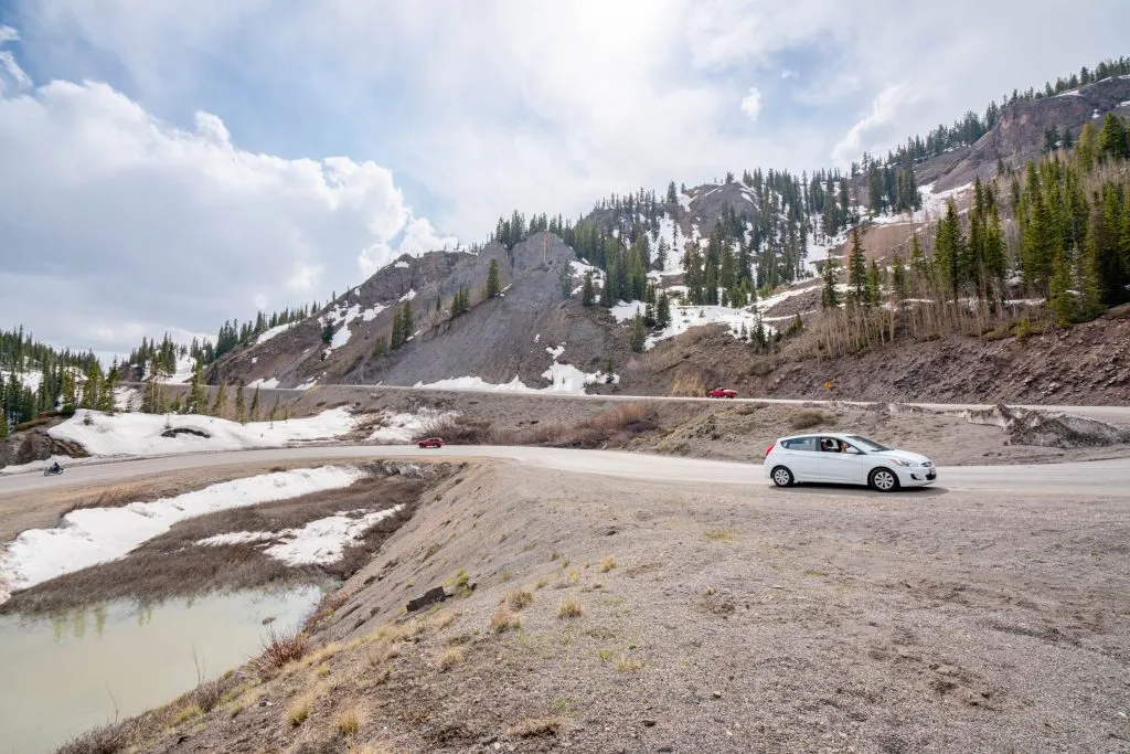 white hyundai accent parked on the million dollar highway in colorado