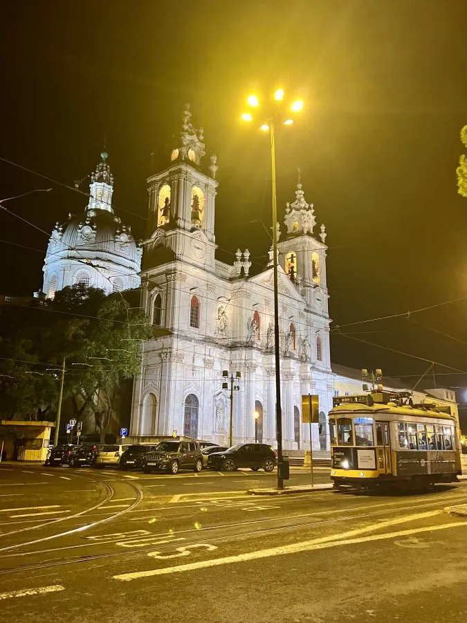 tram in front of basilica da estrela as seen when visiting lisbon at night