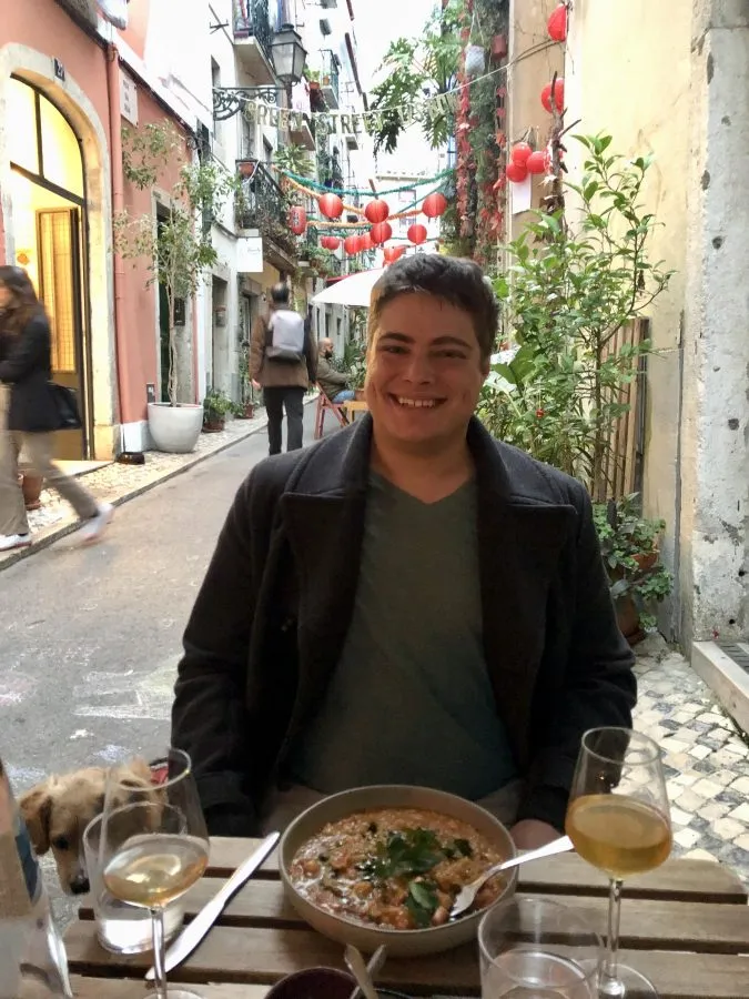 jeremy storm eating dinner on green street lisbon evening