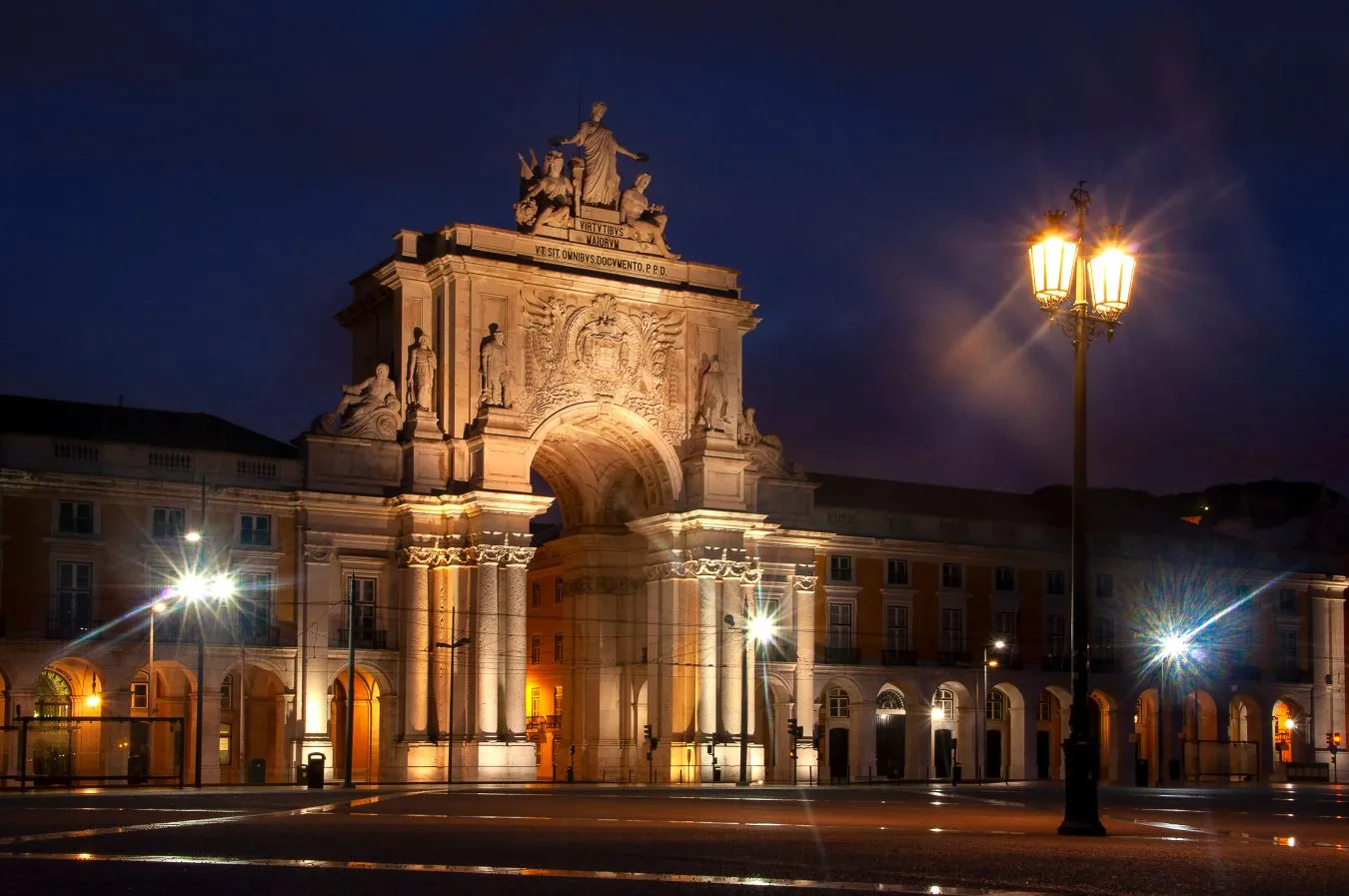 view of praca do comercia and rua augusta arch in lisbon night