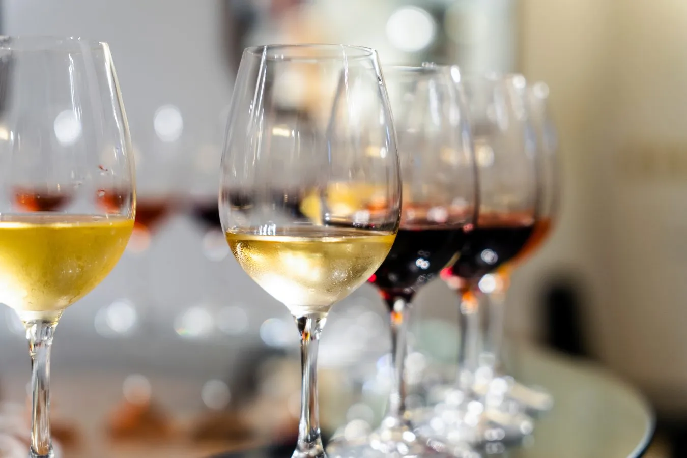 several wine glasses arranged for a wine tasting in lisbon evening activities