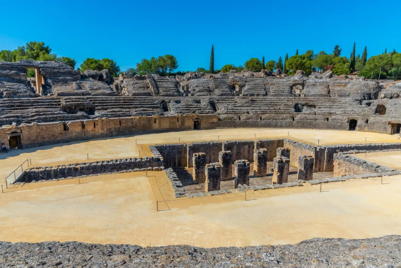 roman amphitheatre in italica on a sunny day, one of the best places to visit near sevilla spain