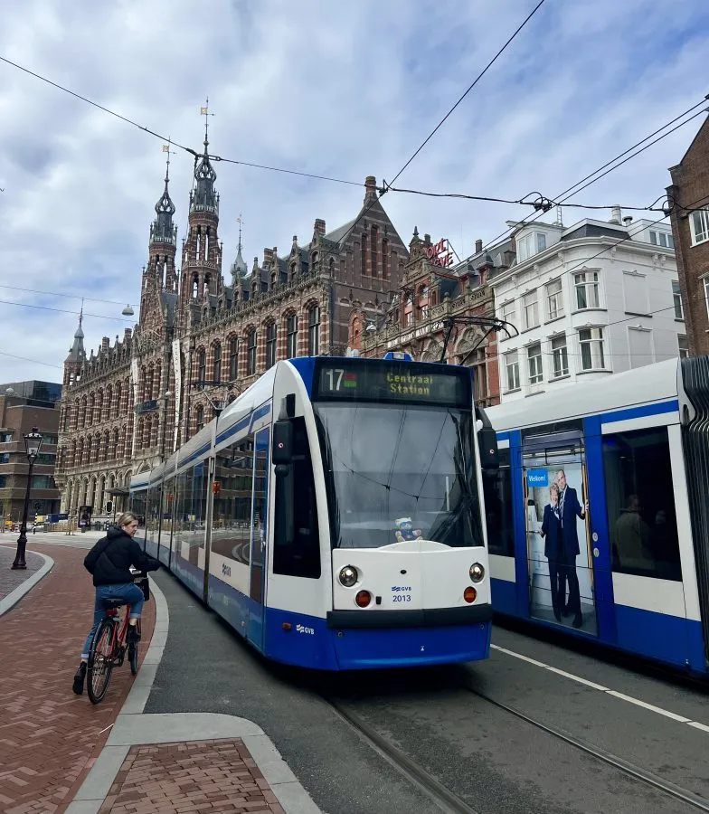 two trams passing each other, as seen when visiting amsterdam for a day