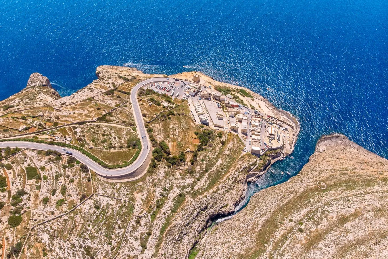 aerial view of blue grotto area with road approaching it visible on the left