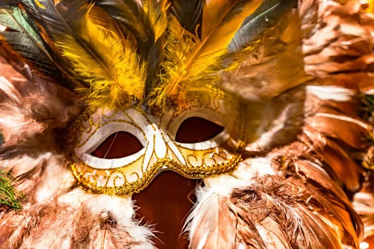 gold and white mardi gras mask, one of the best new orleans souvenirs to shop for