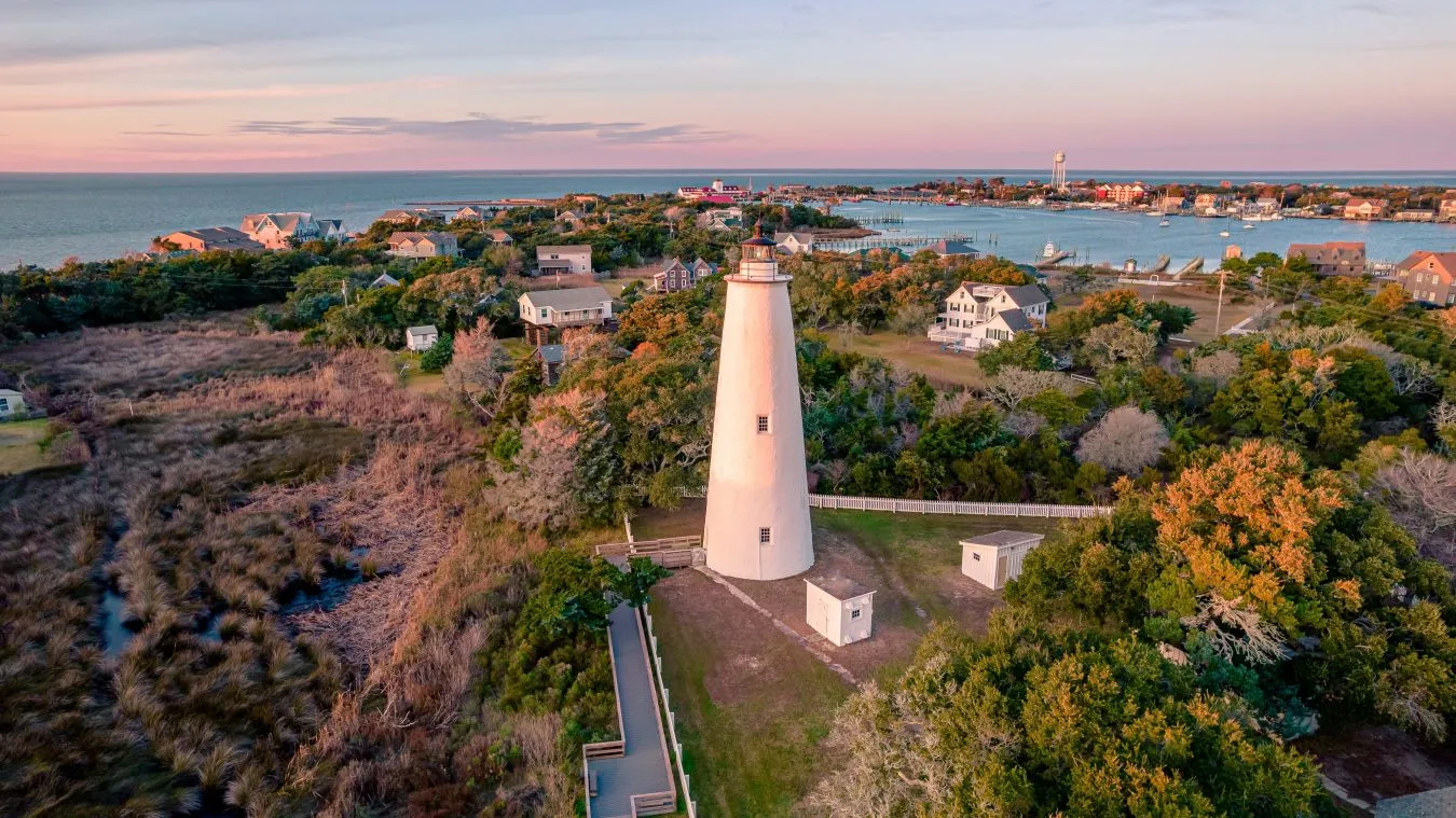 aerial view of ocracoke lighthouse and island at sunset, one of the prettiest east coast beach towns