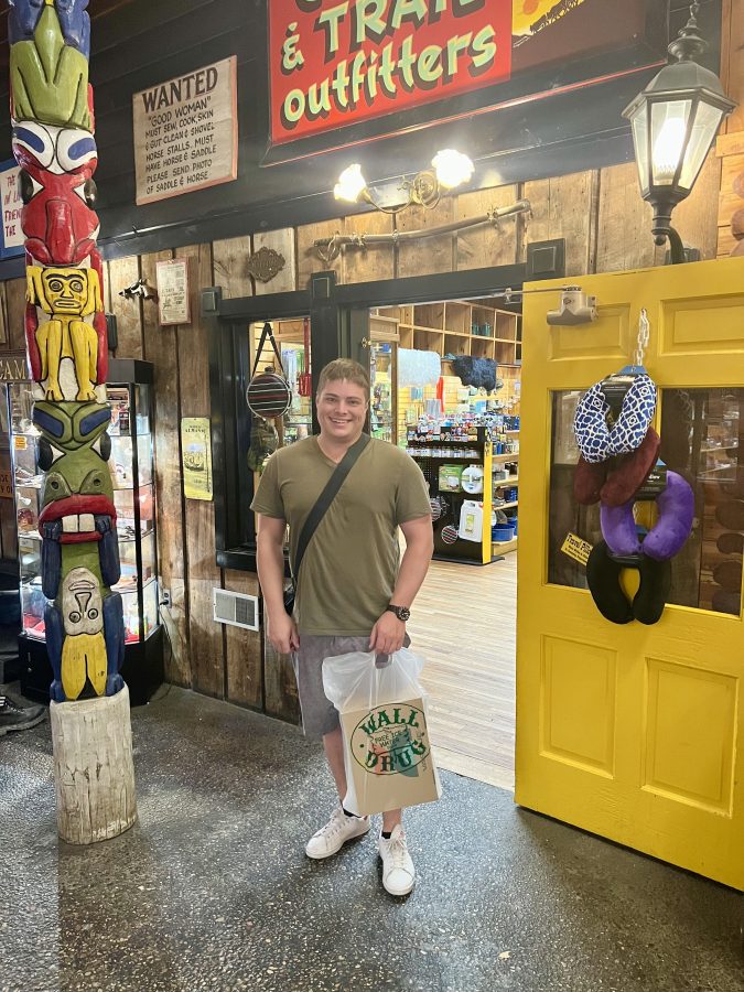 jeremy storm holding a bag with new shoes in it after shopping at wall drug in south dakota