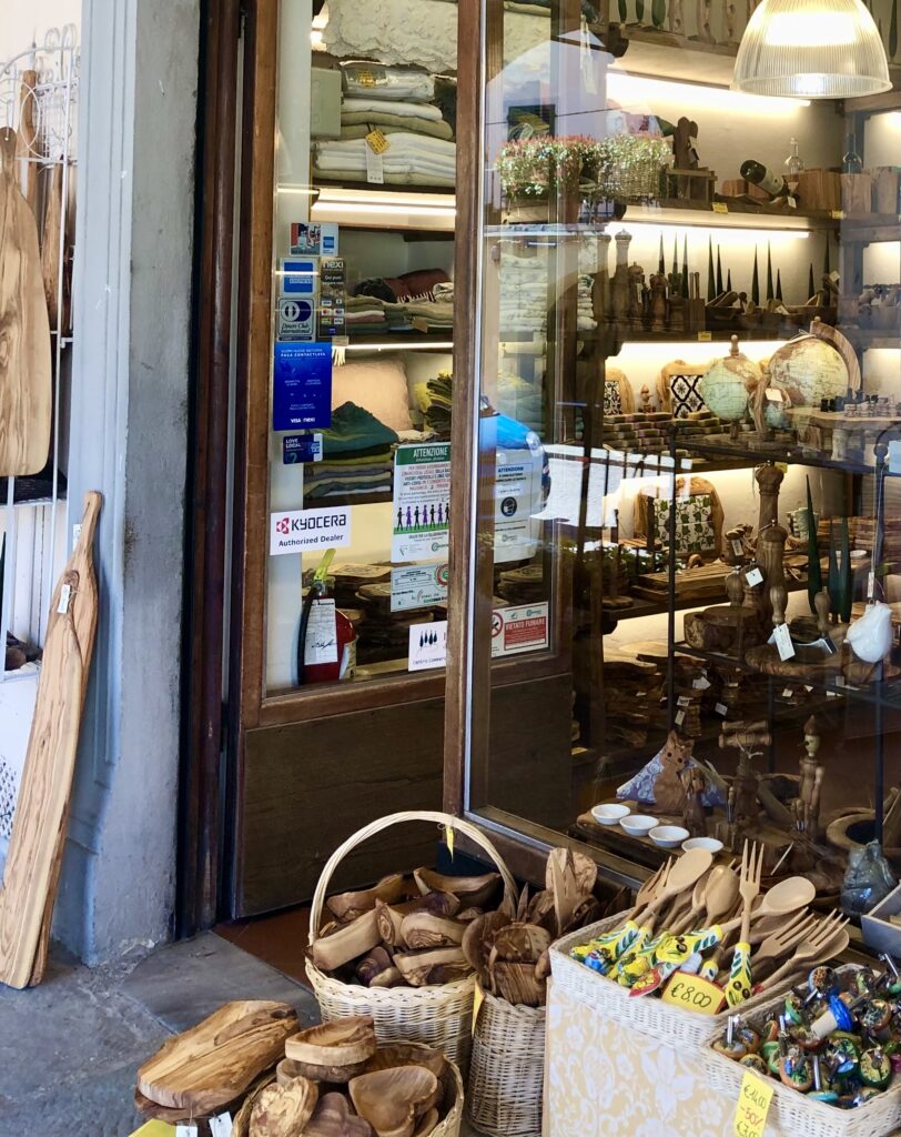 kitchen accessories made from olive wood for sale outside a shop in tuscany italy