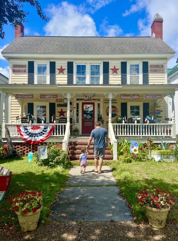 jeremy storm and his toddler walking toward parsons general store on a sunny day